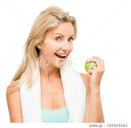 Portrait, fitness and apple with a senior woman in studio isolated on a white background for health. Exercise, diet and lifestyle with a mature female athlete eating fruit for nutrition or weightloss 105829161