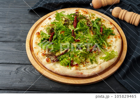 Fresh tasty pizza on black wooden background 105829465