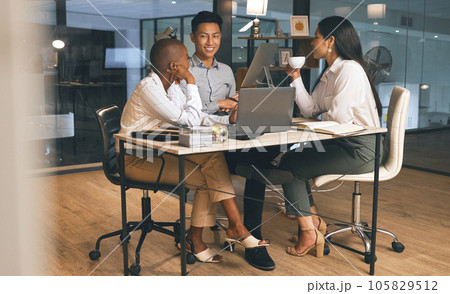 Working towards a mutual goal. Shot of a group of businesspeople working late in a modern office. Working towards a mutual goal. Shot of a group of businesspeople working late in a modern office. 105829512