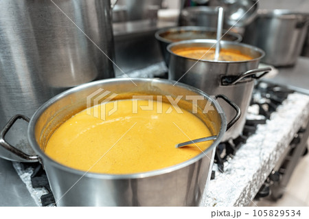 Food preparing in metal pots on the stove at professional kitchen 105829534