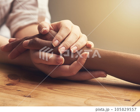 Empathy, trust and support with people holding hands as friends in solidarity in cancer pain, grief or loss. Mental health, depression and love between friends during prayer together or faith in god 105829557