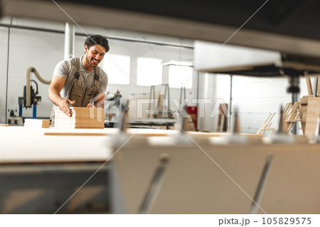 Young man doing woodwork in carpentry factory 105829575