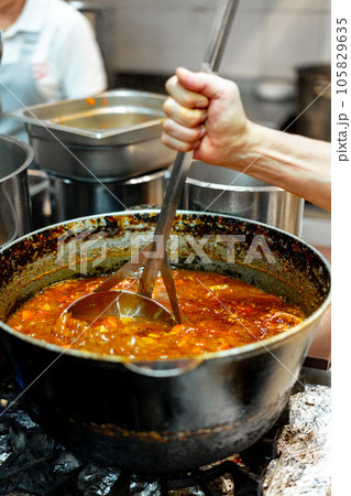 Chef cooking food at restaurant kitchen close up 105829635