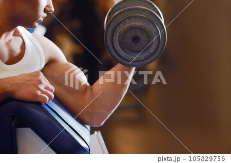 Arm strength, dumbbell and man with training routine, athlete determination or focus on power, health or club challenge. Determined, healthy fitness and ripped person workout for strong bicep growth Arm strength, dumbbell and man with training routine, athlete determination or focus on power, health or club challenge. Determined, healthy fitness and ripped person workout for strong bicep growth 105829756