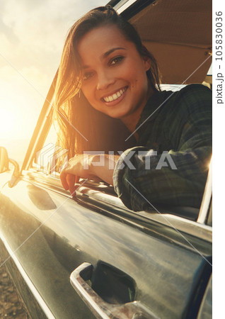 Portrait, driver and road trip with a black woman in a car at sunset during summer vacation or travel. Nature, window and drive with an attractive young female sitting in transport for adventure Portrait, driver and road trip with a black woman in a car at sunset during summer vacation or travel. Nature, window and drive with an attractive young female sitting in transport for adventure 105830036