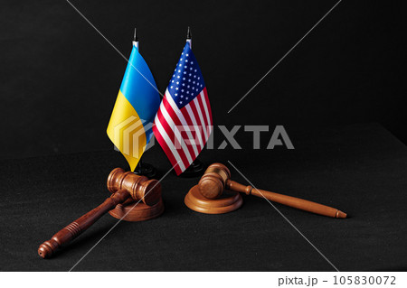 Two judge's gavels with USA flag and flag of Ukraine on black background Two judge's gavels with USA flag and flag of Ukraine on black background 105830072
