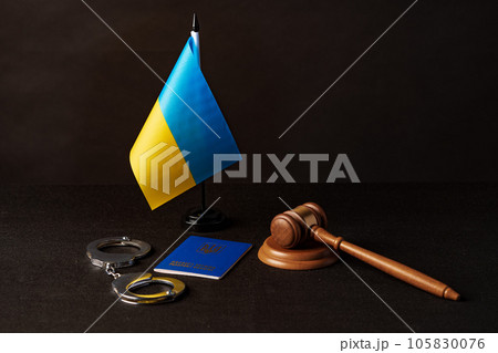 Ukrainian flag and handcuffs on black background, concept of crime and justice in the country Ukrainian flag and handcuffs on black background, concept of crime and justice in the country 105830076