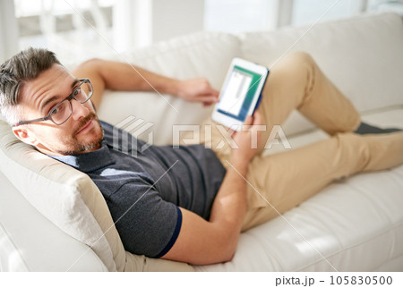 Man, portrait and tablet on living room sofa, reading and social media for video, game or movies in home. Mature guy, digital touchscreen and lounge couch for internet blog, news and web app in house Man, portrait and tablet on living room sofa, reading and social media for video, game or movies in home. Mature guy, digital touchscreen and lounge couch for internet blog, news and web app in house 105830500
