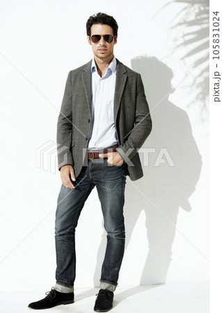 Cool, sunglasses and portrait of a man with fashion isolated on a white background in a studio. Stylish, young and a model with confidence and fashionable clothes with shades and shadow on backdrop 105831024