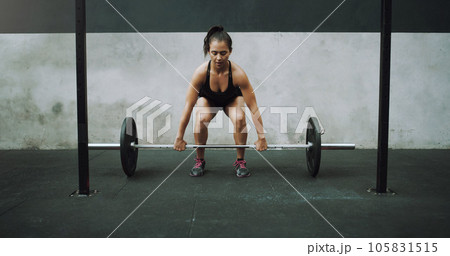 Weight lifting, fitness and woman with barbell for strong body in gym for training, exercise and workout. Sports, deadlift and female bodybuilder lift weights for challenge, wellness and strength Weight lifting, fitness and woman with barbell for strong body in gym for training, exercise and workout. Sports, deadlift and female bodybuilder lift weights for challenge, wellness and strength 105831515