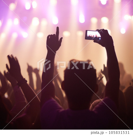 Fan, phone filming and band on stage with excited audience, lighting colors and music performance on video. Smartphone screen, photography and festival crowd at night and concert, event or party Fan, phone filming and band on stage with excited audience, lighting colors and music performance on video. Smartphone screen, photography and festival crowd at night and concert, event or party 105831531