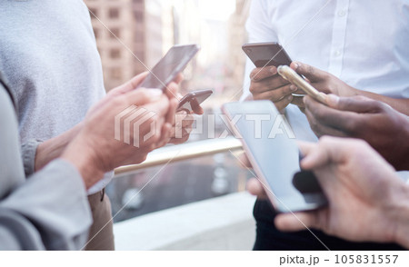 When you need to innovate, you need collaboration.. Cropped shot of a group of unrecognizable businesspeople using their cellphones. 105831557