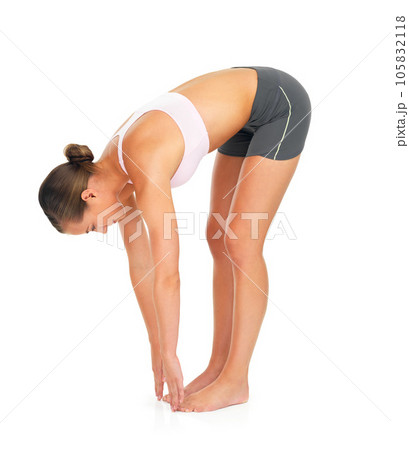 Fitness, exercise and woman stretching in a studio for wellness, healthy training and wellbeing. Sports, health and slim female model doing a warm up workout while isolated by a white background. Fitness, exercise and woman stretching in a studio for wellness, healthy training and wellbeing. Sports, health and slim female model doing a warm up workout while isolated by a white background. 105832118