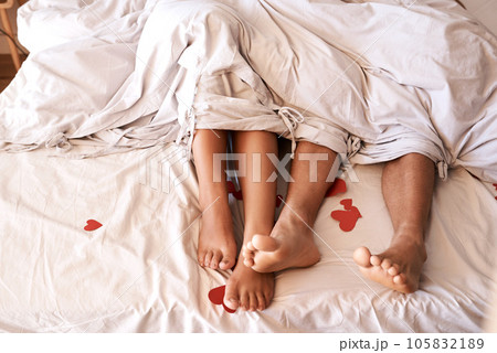 Bed, legs and couple with Valentines Day heart, romance or emoji icon for home love, intimacy and honeymoon affection. Marriage bond, relax sleep and top view feet of people sleeping in hotel bedroom Bed, legs and couple with Valentines Day heart, romance or emoji icon for home love, intimacy and honeymoon affection. Marriage bond, relax sleep and top view feet of people sleeping in hotel bedroom 105832189