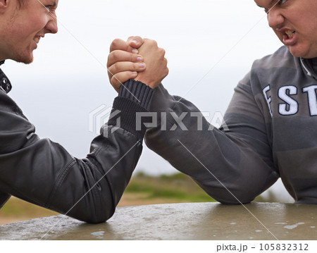Closeup, friends and competition with men and arm wrestling in nature for challenge, power and respect. Team, strong and conflict with hands of people and holding hands for muscle, match and rival 105832312