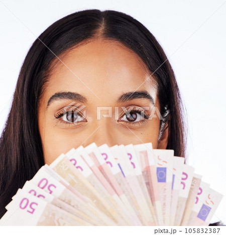 Portrait, cash and a woman lottery winner in studio on a white background in celebration of a bonus or promotion. Eyes, money and finance payment with the face of a young person holding euro notes Portrait, cash and a woman lottery winner in studio on a white background in celebration of a bonus or promotion. Eyes, money and finance payment with the face of a young person holding euro notes 105832387
