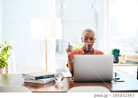 The most effective way to do it is simply to do it. Shot of a young businesswoman wearing earphones while working on a laptop in an office. The most effective way to do it is simply to do it. Shot of a young businesswoman wearing earphones while working on a laptop in an office. 105832563