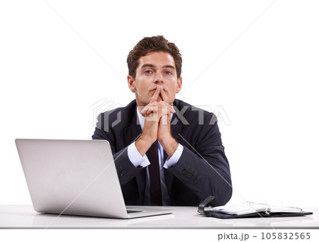 Managing his diary. A pensive young businessman sitting in front of his laptop. 105832565