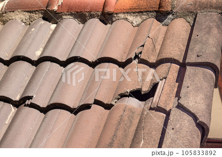 Damaged old roof tile in need of repair. Damaged old roof tile in need of repair. 105833892