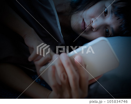 Woman Sleep on Bed and Looking Mobile in Night,She Wait Call Back from Husband with Sad and stressed,Lonely,Girl Unhappy Broken Heart and Problem,Authentic Black Hair and Skin Tan Asian. Woman Sleep on Bed and Looking Mobile in Night,She Wait Call Back from Husband with Sad and stressed,Lonely,Girl Unhappy Broken Heart and Problem,Authentic Black Hair and Skin Tan Asian. 105834746