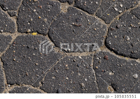Damaged asphalt pavement , close up 105835551