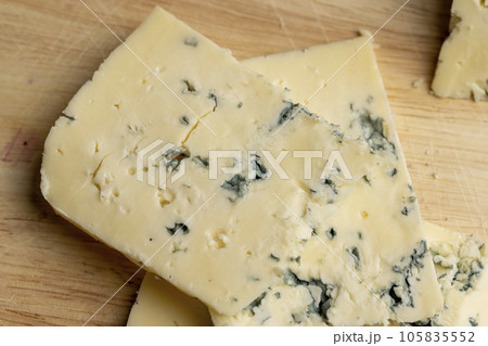 Cheese with blue mold cut into pieces Cheese with blue mold cut into pieces 105835552