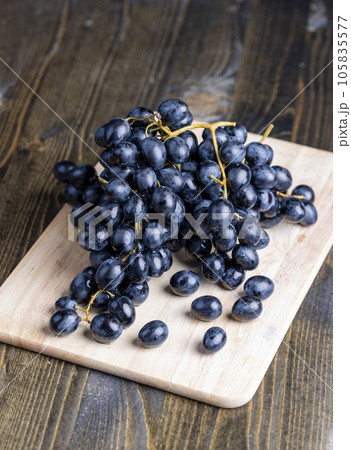 Unwashed blue grapes in the dust 105835577