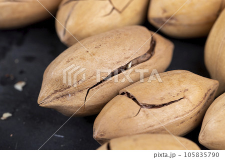 cracked unpeeled pecans close-up on the table cracked unpeeled pecans close-up on the table 105835790