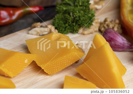 Sliced hard cheese made from milk 105836052