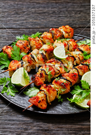 chicken souvlaki with parsley and lime on plate chicken souvlaki with parsley and lime on plate 105837107