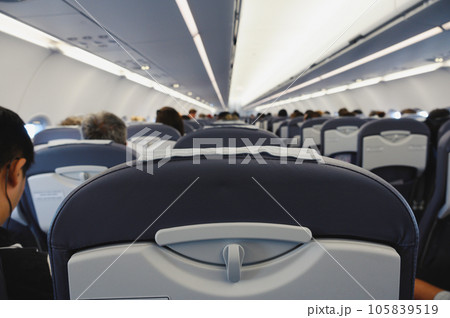 Interior of an airliner with traveler people 105839519