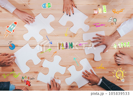 Businessmen working together to build a puzzle as teamwork, partnership and integration concept 105839533
