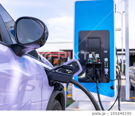 Electric cars parked for charging at power stations. 105840195