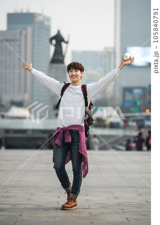 A young man traveling in Seoul, South Korea, with a backpack A young man traveling in Seoul, South Korea, with a backpack 105840791