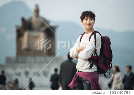 A young man traveling in Seoul, South Korea, with a backpack A young man traveling in Seoul, South Korea, with a backpack 105840798