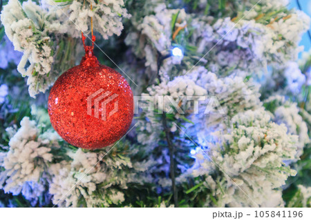 Christmas tree decorated with red ball on pine branches background Christmas tree decorated with red ball on pine branches background 105841196
