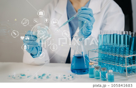 Lab work, Doctor holds a test tube takes the test from a test tube in analysis, blood, DNA, test tube stand. 105841683