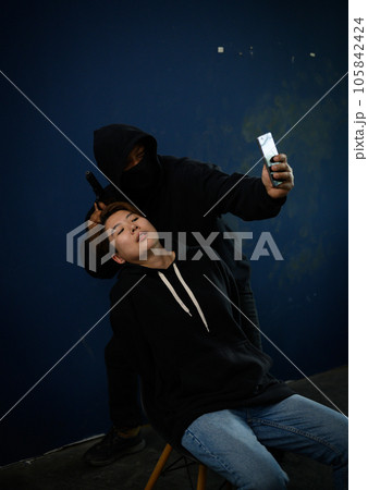 Masked criminal with guns and woman hostage reports the ransom selfie the video call Masked criminal with guns and woman hostage reports the ransom selfie the video call 105842424