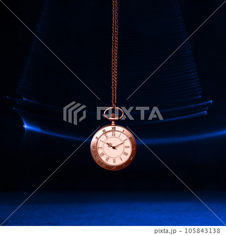 Hypnosis session. Vintage pocket watch with chain swinging over surface on dark background among faded clock faces, magic motion effect 105843138