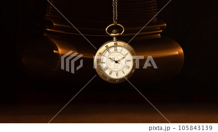 Hypnosis session. Vintage pocket watch with chain swinging over surface on dark background among faded clock faces, magic motion effect Hypnosis session. Vintage pocket watch with chain swinging over surface on dark background among faded clock faces, magic motion effect 105843139
