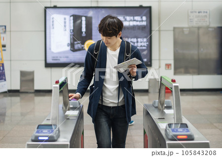 a young man on the subway with a map 105843208