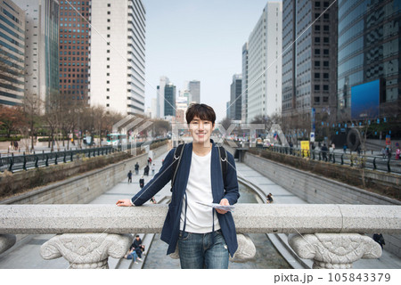 A young man traveling in Seoul, South Korea, with a backpack A young man traveling in Seoul, South Korea, with a backpack 105843379