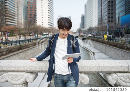A young man traveling in Seoul, South Korea, with a backpack 105843380