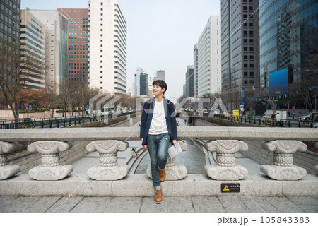 A young man traveling in Seoul, South Korea, with a backpack A young man traveling in Seoul, South Korea, with a backpack 105843383
