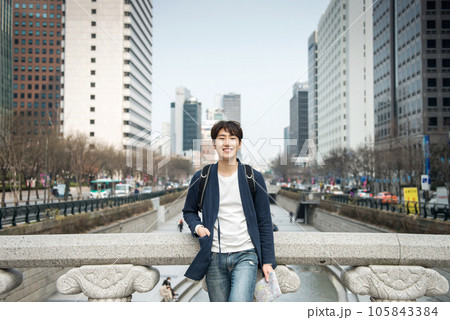 A young man traveling in Seoul, South Korea, with a backpack A young man traveling in Seoul, South Korea, with a backpack 105843384