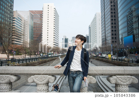 A young man traveling in Seoul, South Korea, with a backpack 105843386