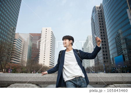 A young man traveling in Seoul, South Korea, with a backpack A young man traveling in Seoul, South Korea, with a backpack 105843460