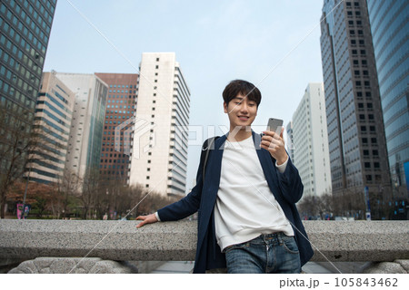 A young man traveling in Seoul, South Korea, with a backpack A young man traveling in Seoul, South Korea, with a backpack 105843462