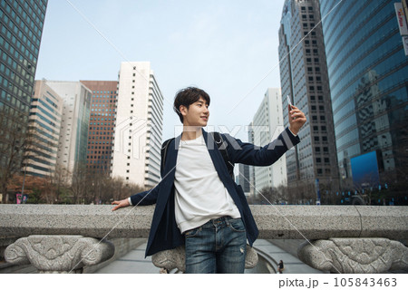 A young man traveling in Seoul, South Korea, with a backpack 105843463