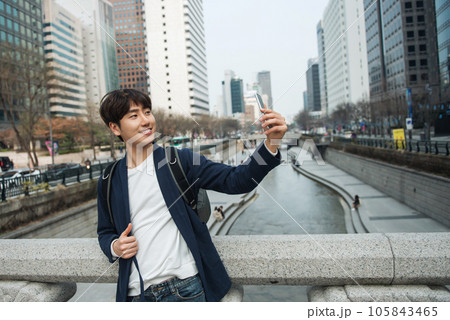 A young man traveling in Seoul, South Korea, with a backpack 105843465